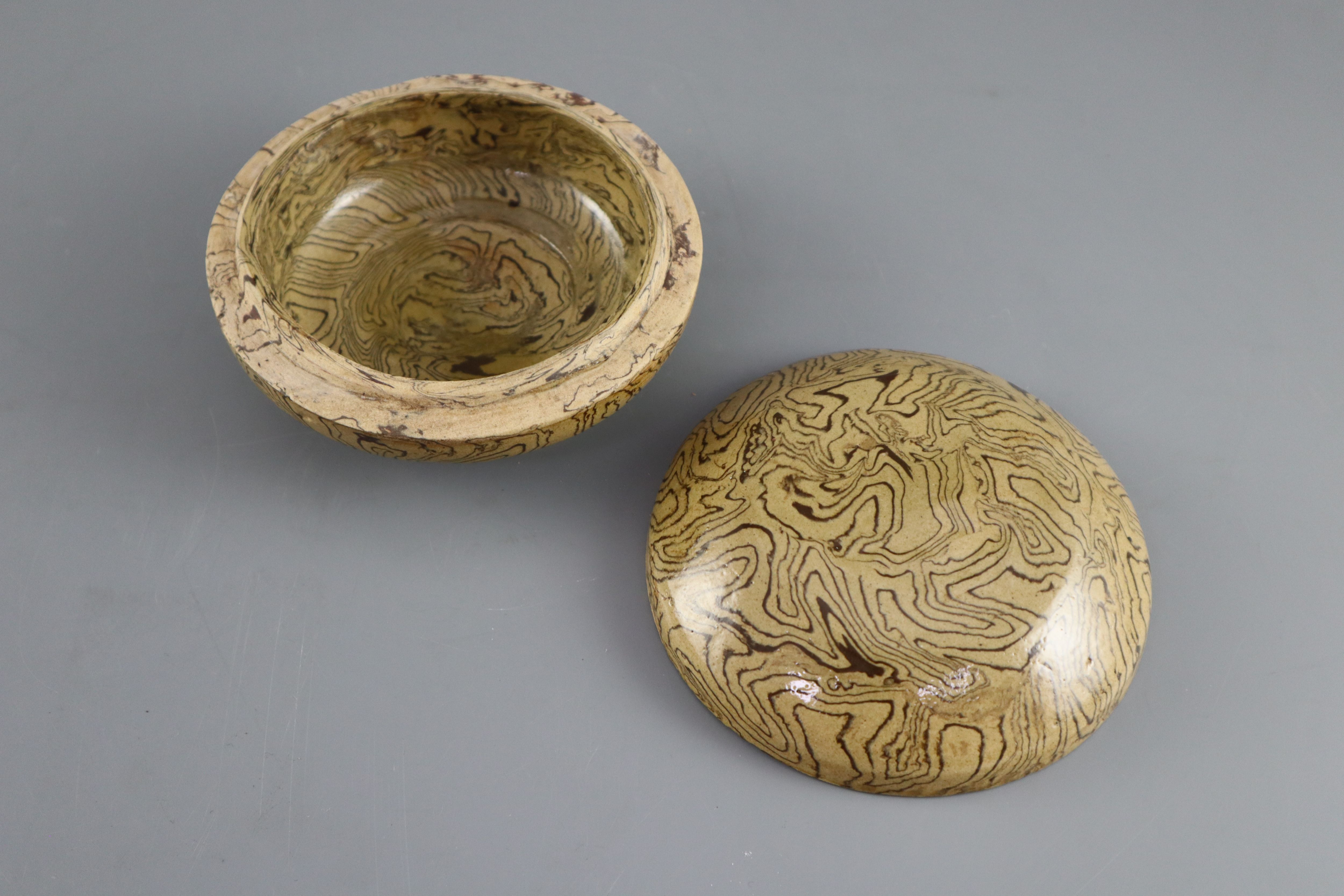A Chinese marbled straw glazed box and cover, Tang dynasty or later, 11cm diameter